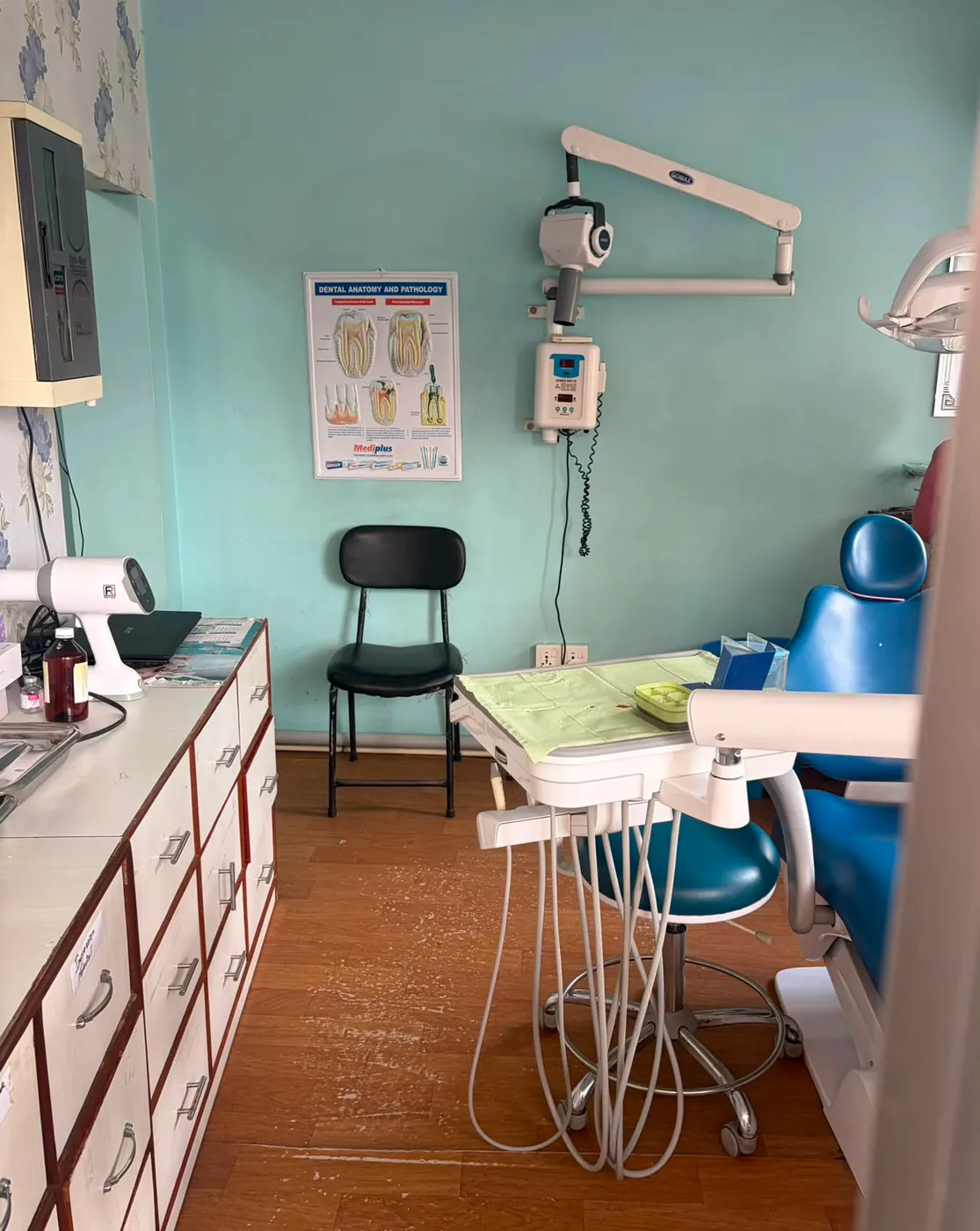 Treatment room with a dental chair and wall-mounted X-ray unit at Gurjudhara Dental Care, Chandragiri