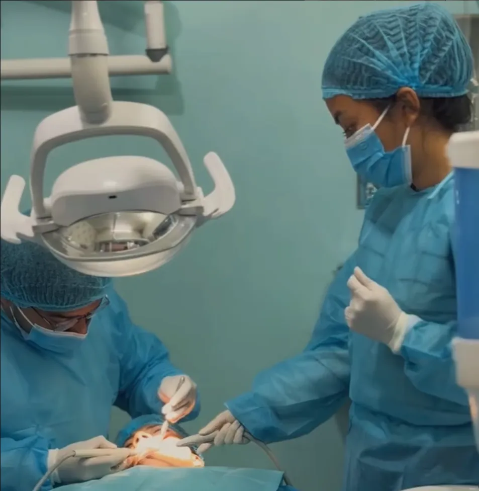 Dental team at work in the treatment room at Gurjudhara Dental Care, Chandragiri