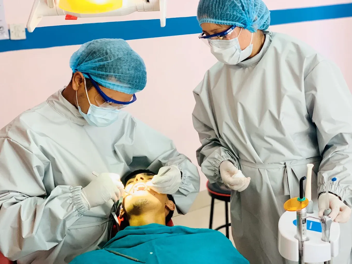 Two dentists at Gurjudhara Dental Care treating one patient together, Chandragiri-12
