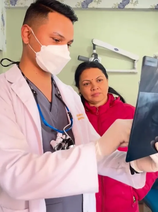 Dentist at Gurjudhara Dental Care showing a patient their dental X-ray, Chandragiri-12