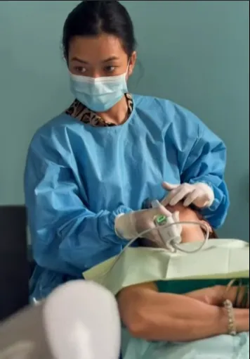 Dentist treating a patient in the dental chair at Gurjudhara Dental Care, Chandragiri