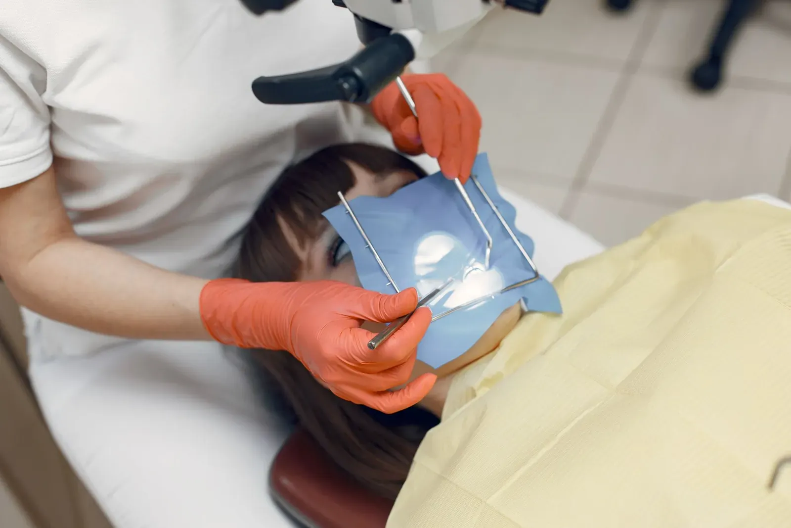 Root canal treatment in progress, the tooth isolated under a rubber dam before the canal is cleaned