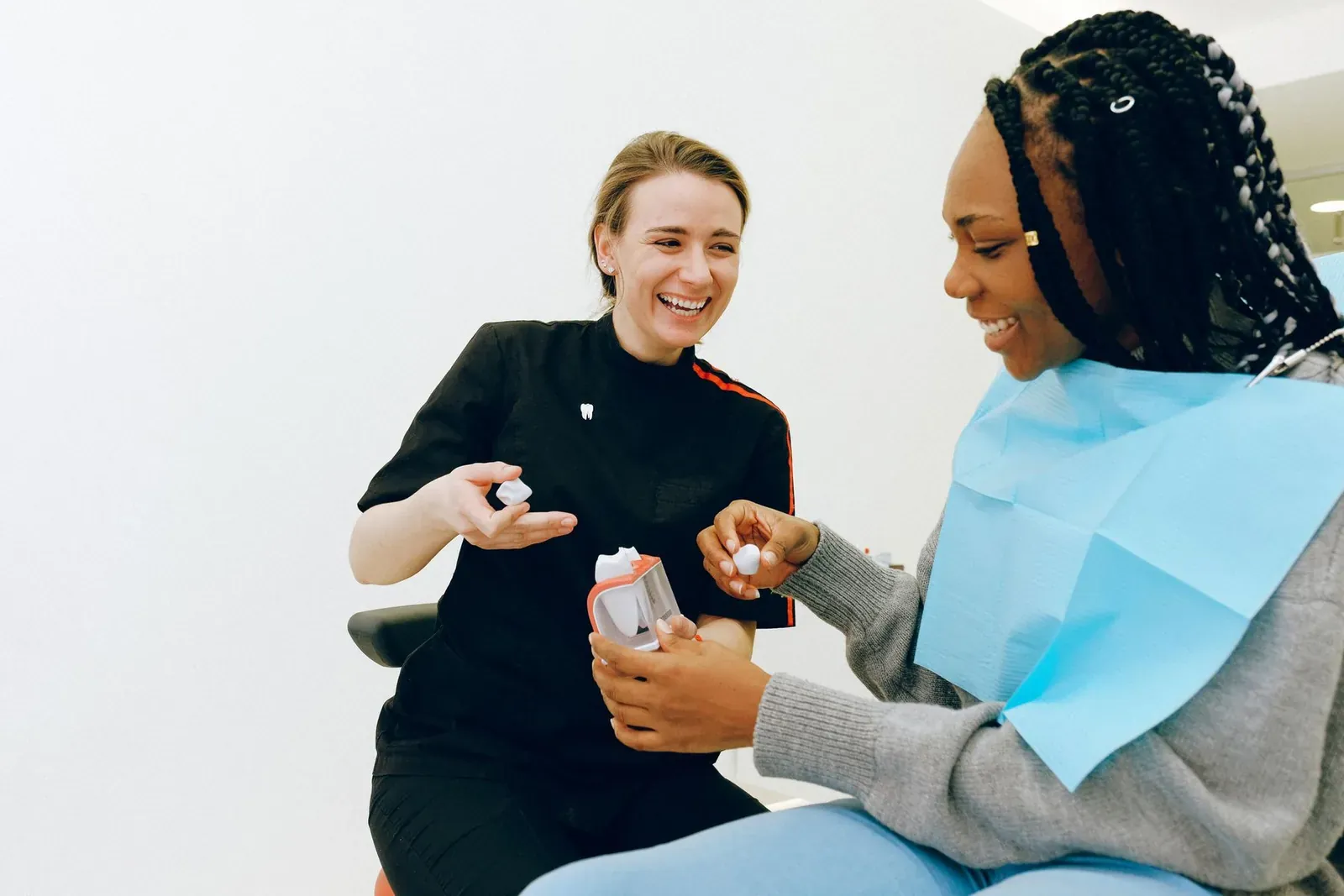 Dentist explaining a treatment plan to a patient sitting in the dental chair