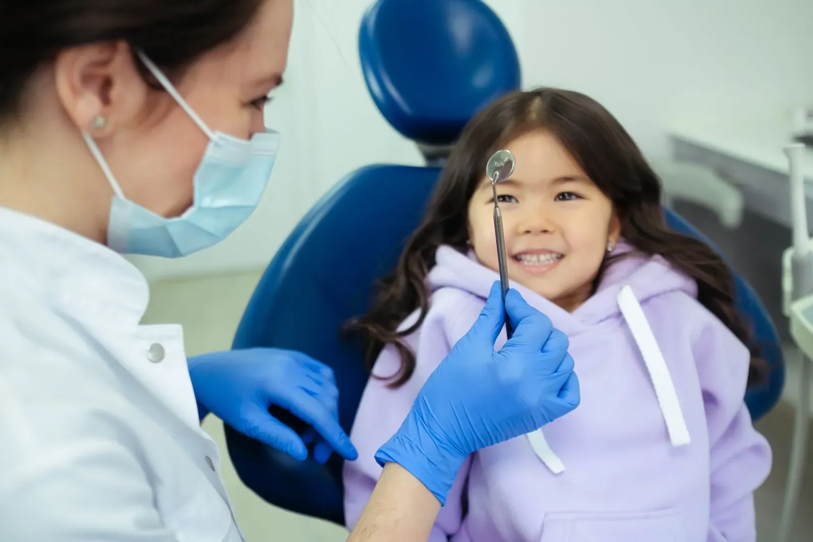 Young child having her teeth checked in the dental chair during a paediatric dental visit